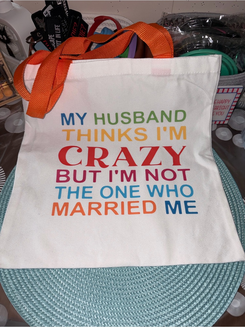 White Tote Bag with Multicolor Text - My Husband Thinks I'm Crazy  14”x13” - Picture 2 of 3